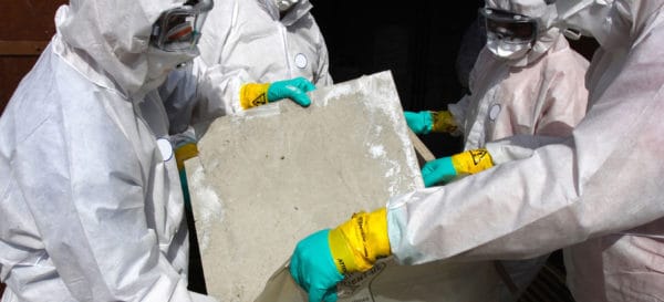 professionals removing an asbestos tile